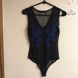 Sheer black onesie with blue flowers.